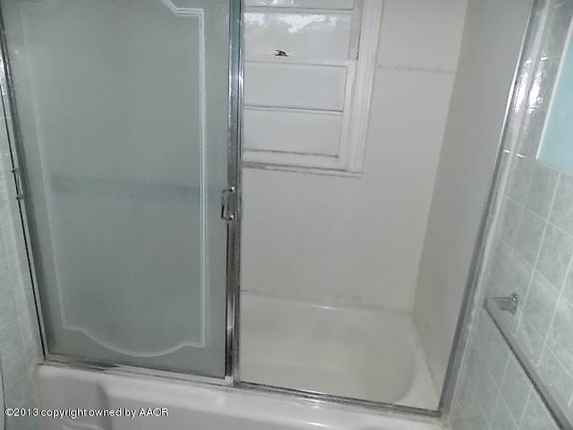4101 South Travis Street Amarillo, TX 79110 - Photo 11 of 14 a bathroom with a glass shower door