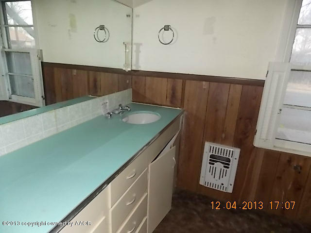 4101 South Travis Street Amarillo, TX 79110 - Photo 5 of 14 a bathroom with a sink and a mirror