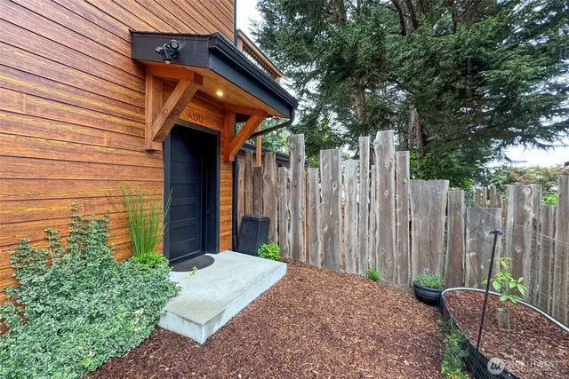a backyard of a house with table and chairs