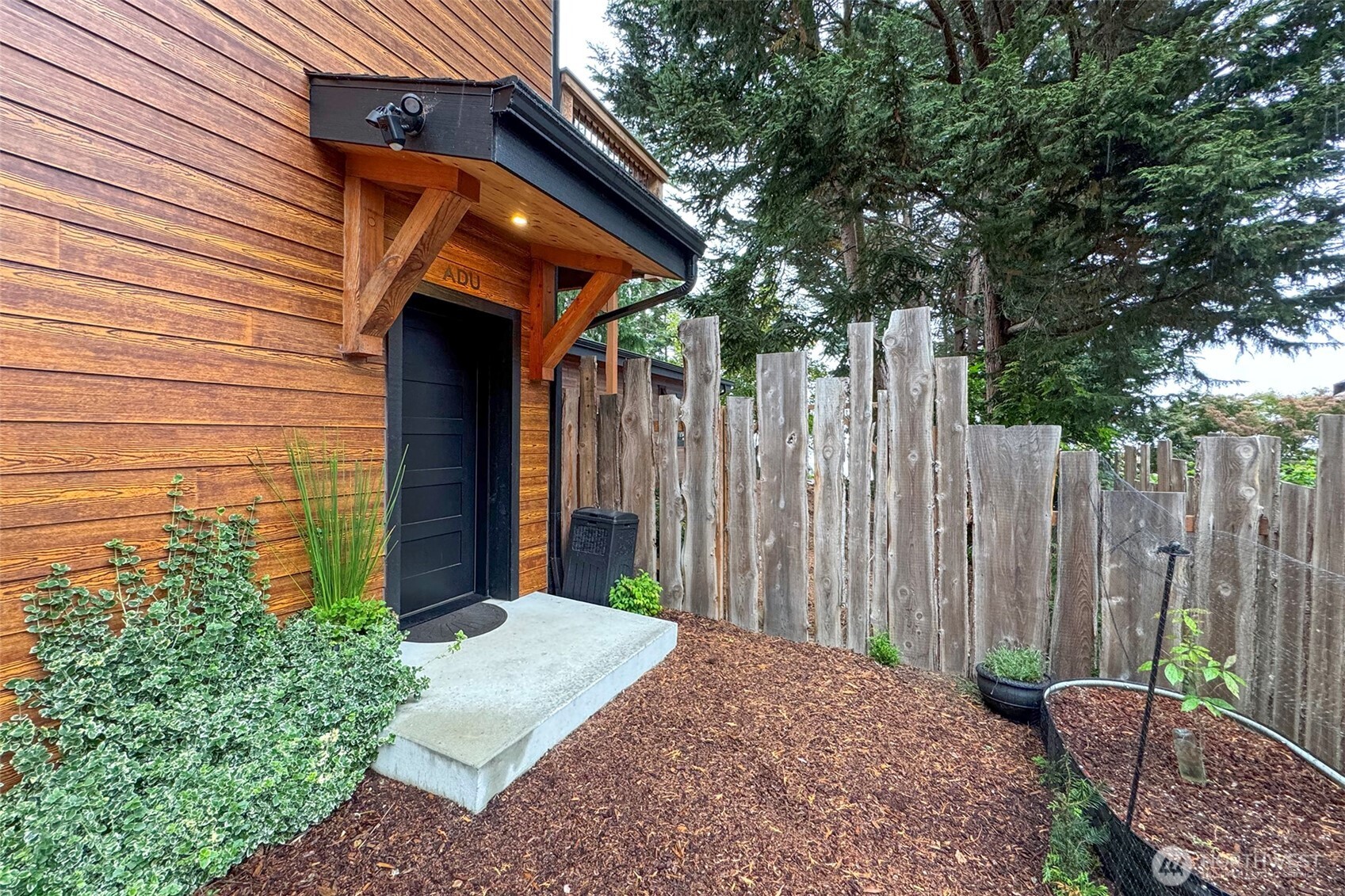 a backyard of a house with table and chairs