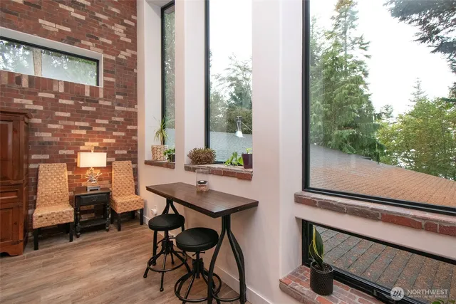 a view of a balcony with chairs and wooden floor