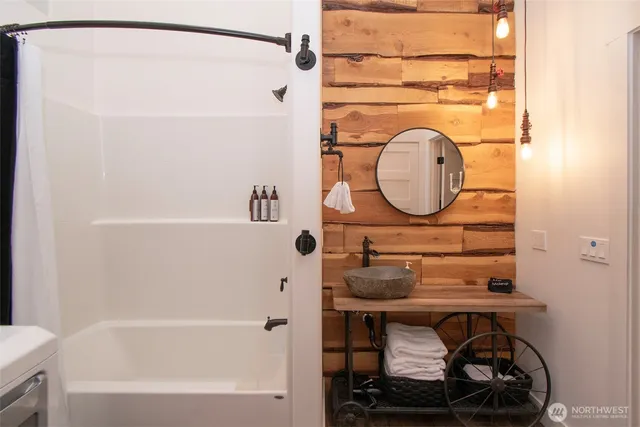 a bathroom with a toilet a sink and mirror