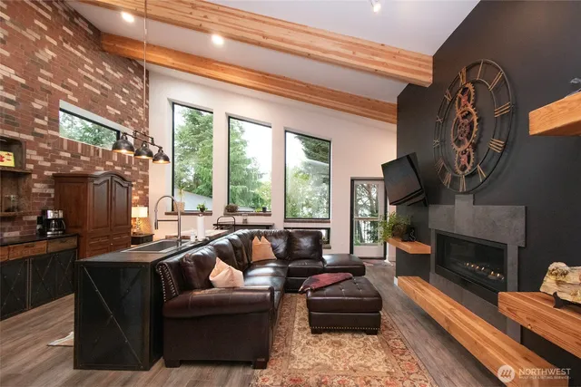a living room with furniture large window and a fireplace