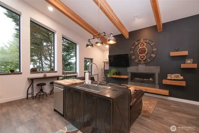 a living room with furniture a fireplace and a large window