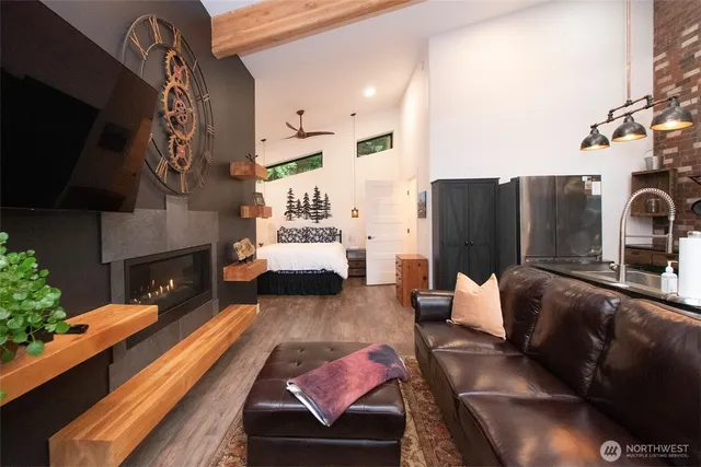 a living room with furniture fireplace and flat screen tv