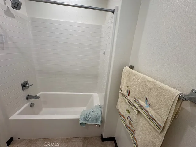 a bathroom with a tub sink and a mirror