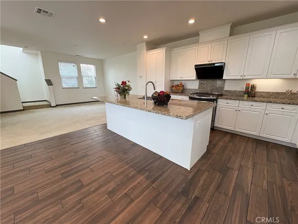 a kitchen with cabinets a sink and appliances
