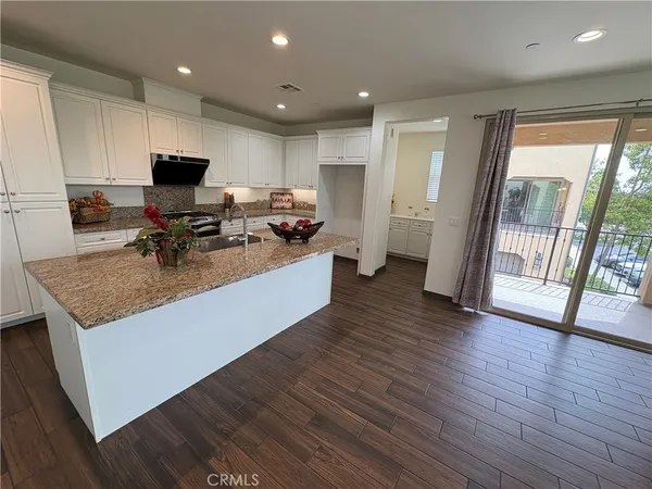 a view of living room with furniture a flat screen tv and a floor to ceiling window
