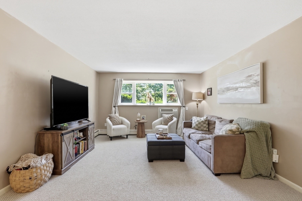 1 Colonial Drive, Unit B1 Andover, MA 01810 - Photo 3 of 14 a living room with furniture and a flat screen tv