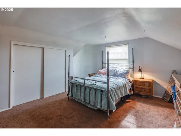 a bedroom with a bed window and couch