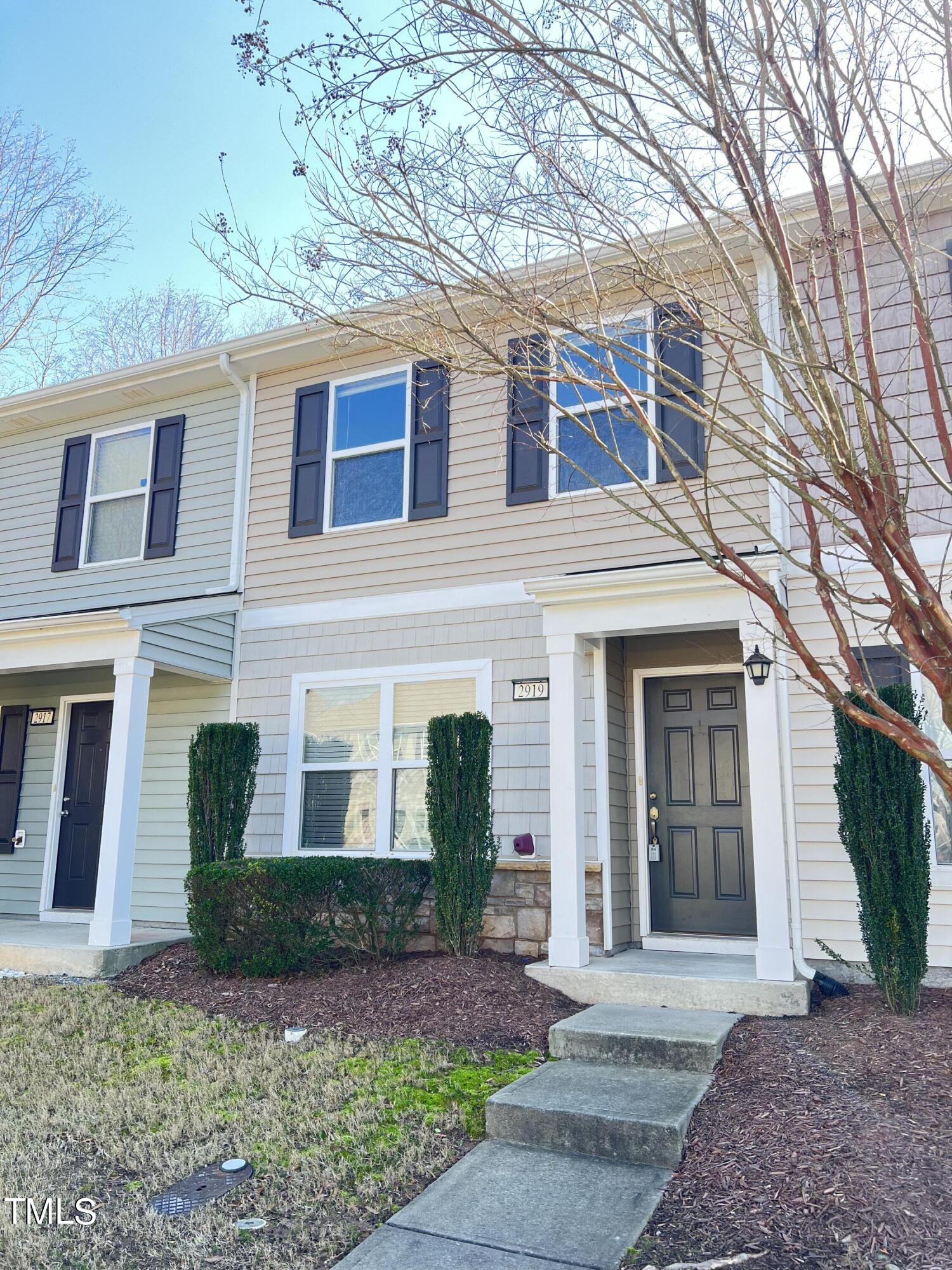 2919 Berkeley Springs Place Raleigh, NC 27616 - Photo 1 of 12 a front view of a house with garden