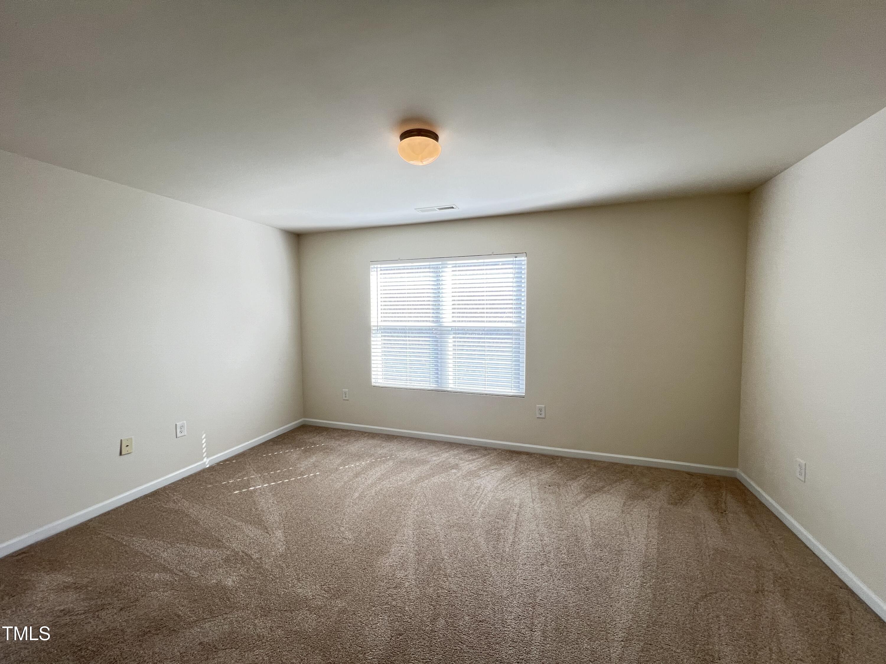 2919 Berkeley Springs Place Raleigh, NC 27616 - Photo 11 of 12 a view of an empty room with a window