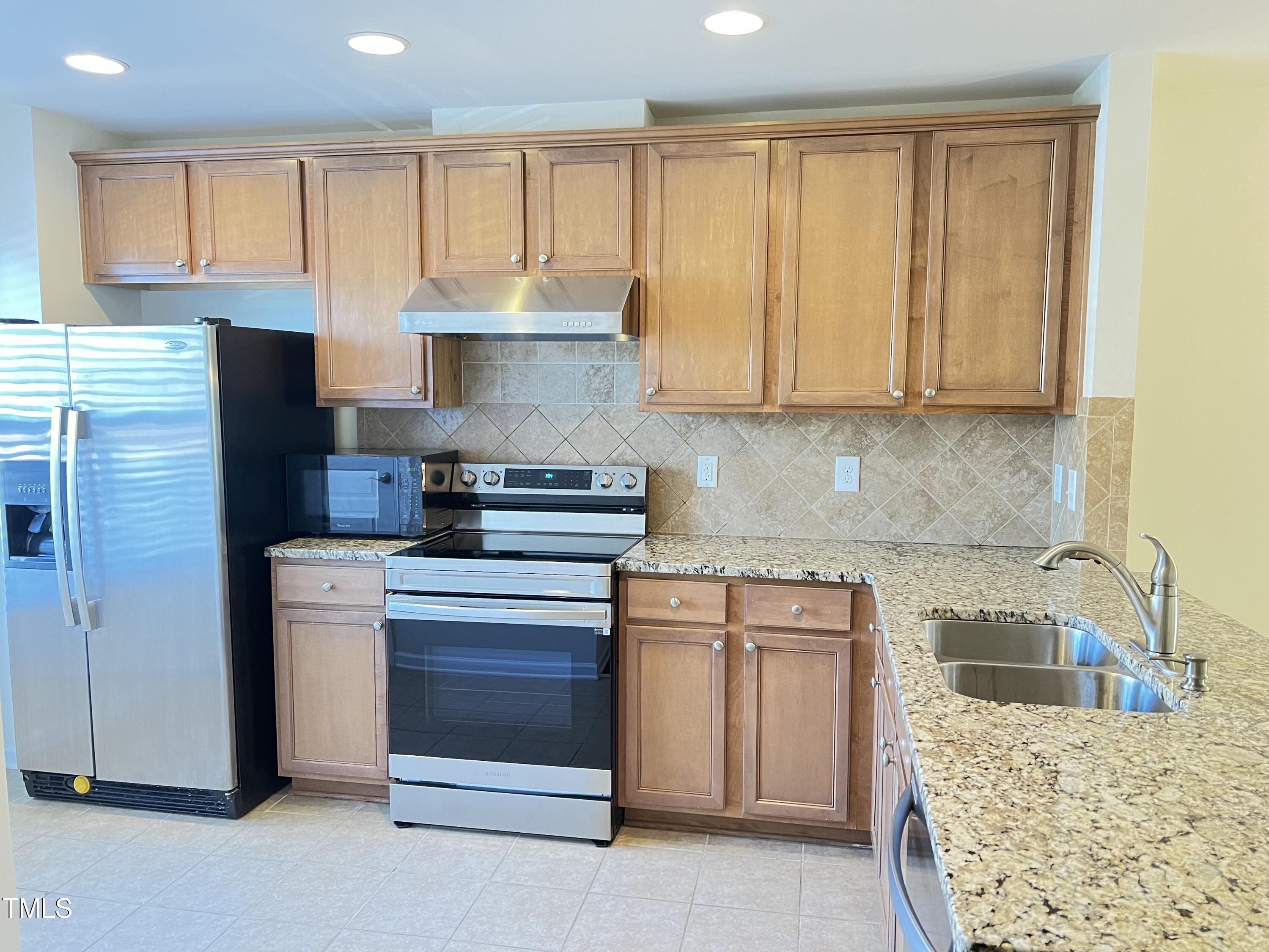 2919 Berkeley Springs Place Raleigh, NC 27616 - Photo 3 of 12 a kitchen with a stove a sink and a microwave