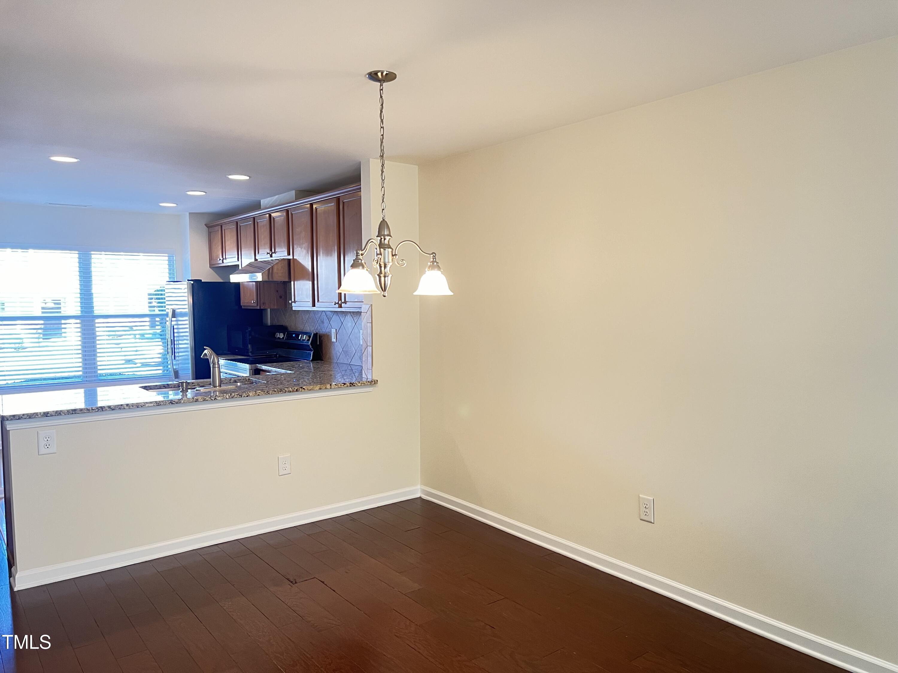 2919 Berkeley Springs Place Raleigh, NC 27616 - Photo 4 of 12 a view of a room with wooden floor and a window