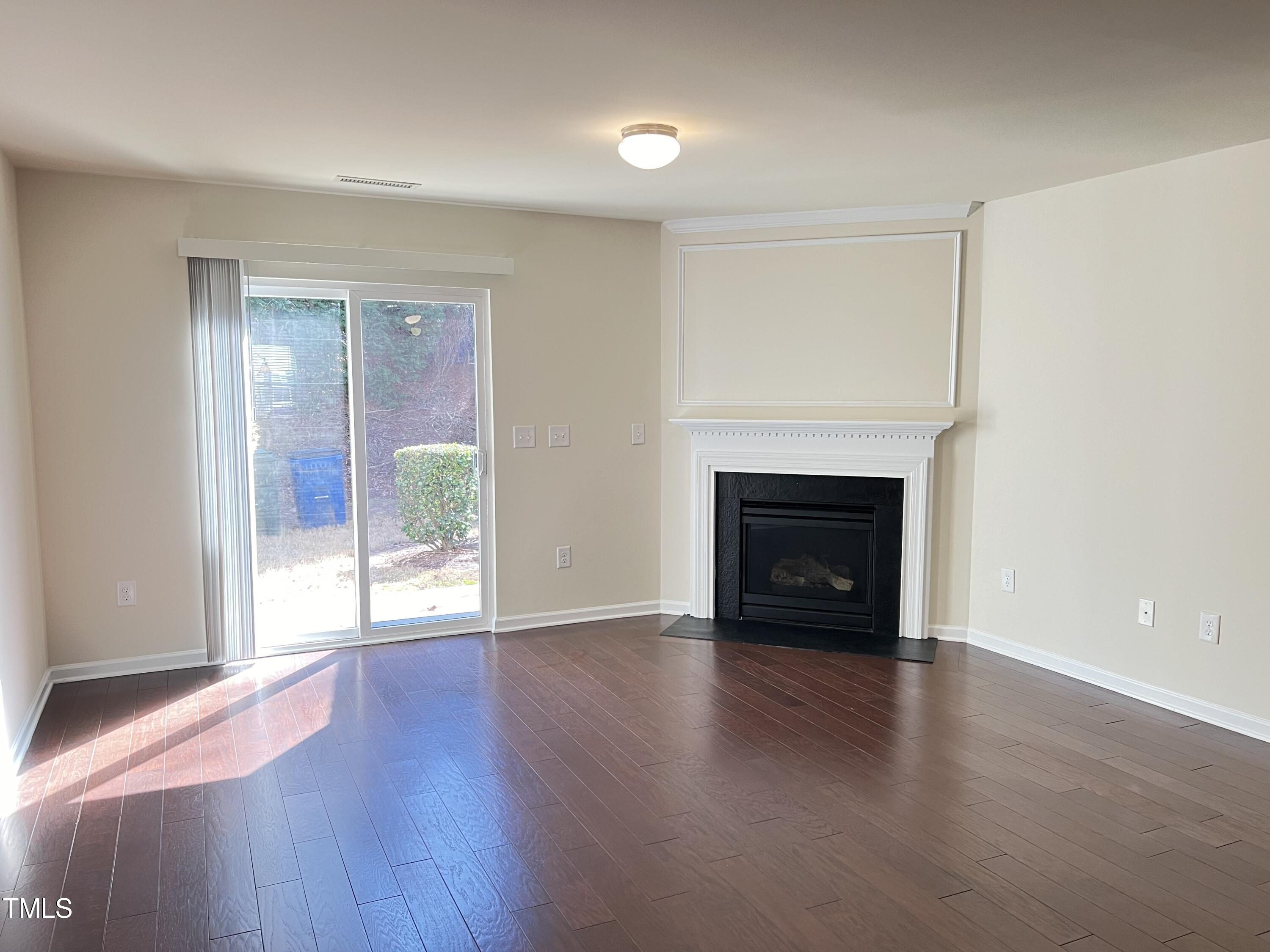 2919 Berkeley Springs Place Raleigh, NC 27616 - Photo 5 of 12 a view of an empty room with glass door and a window