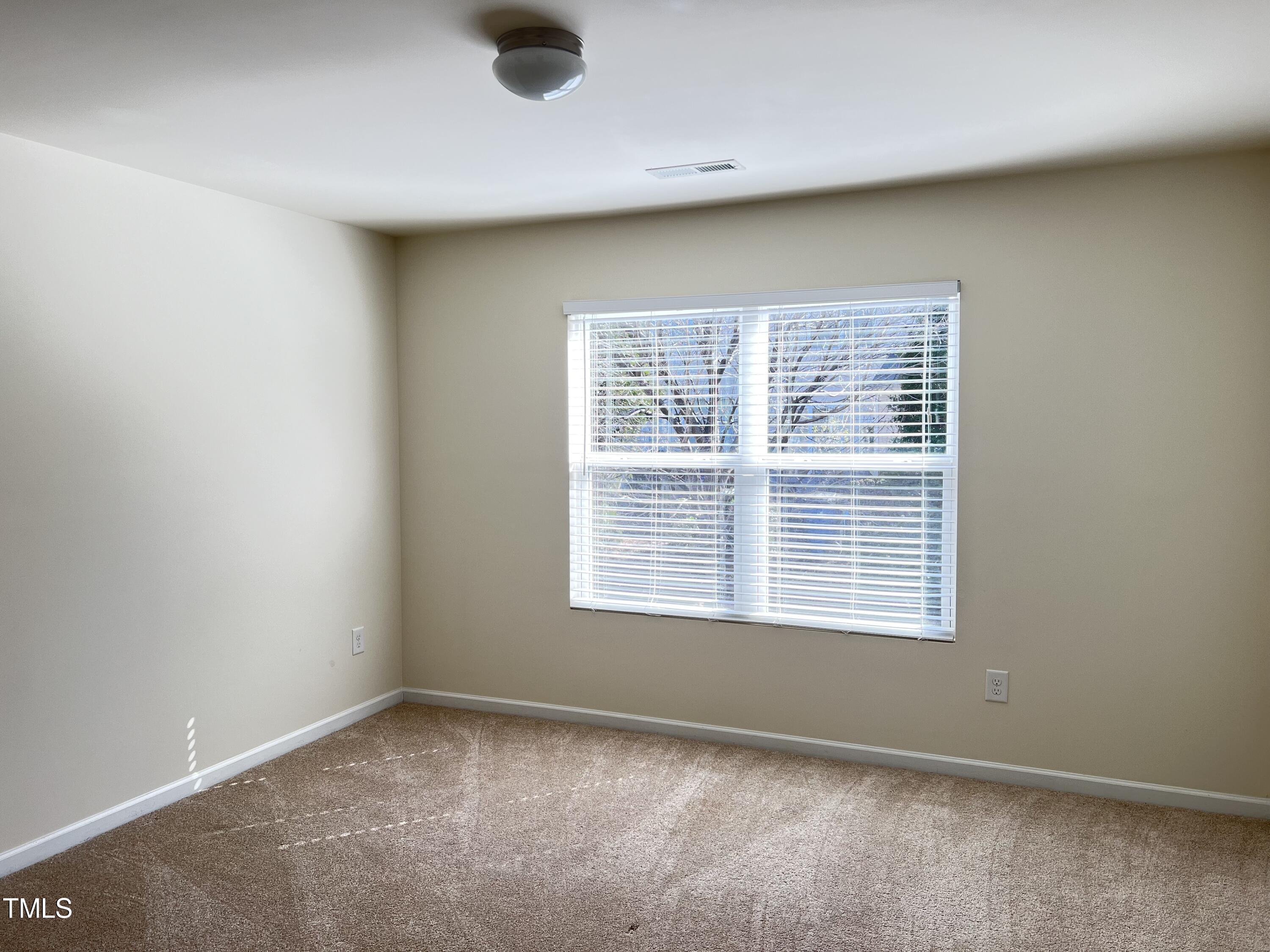 2919 Berkeley Springs Place Raleigh, NC 27616 - Photo 6 of 12 a view of an empty room with a window
