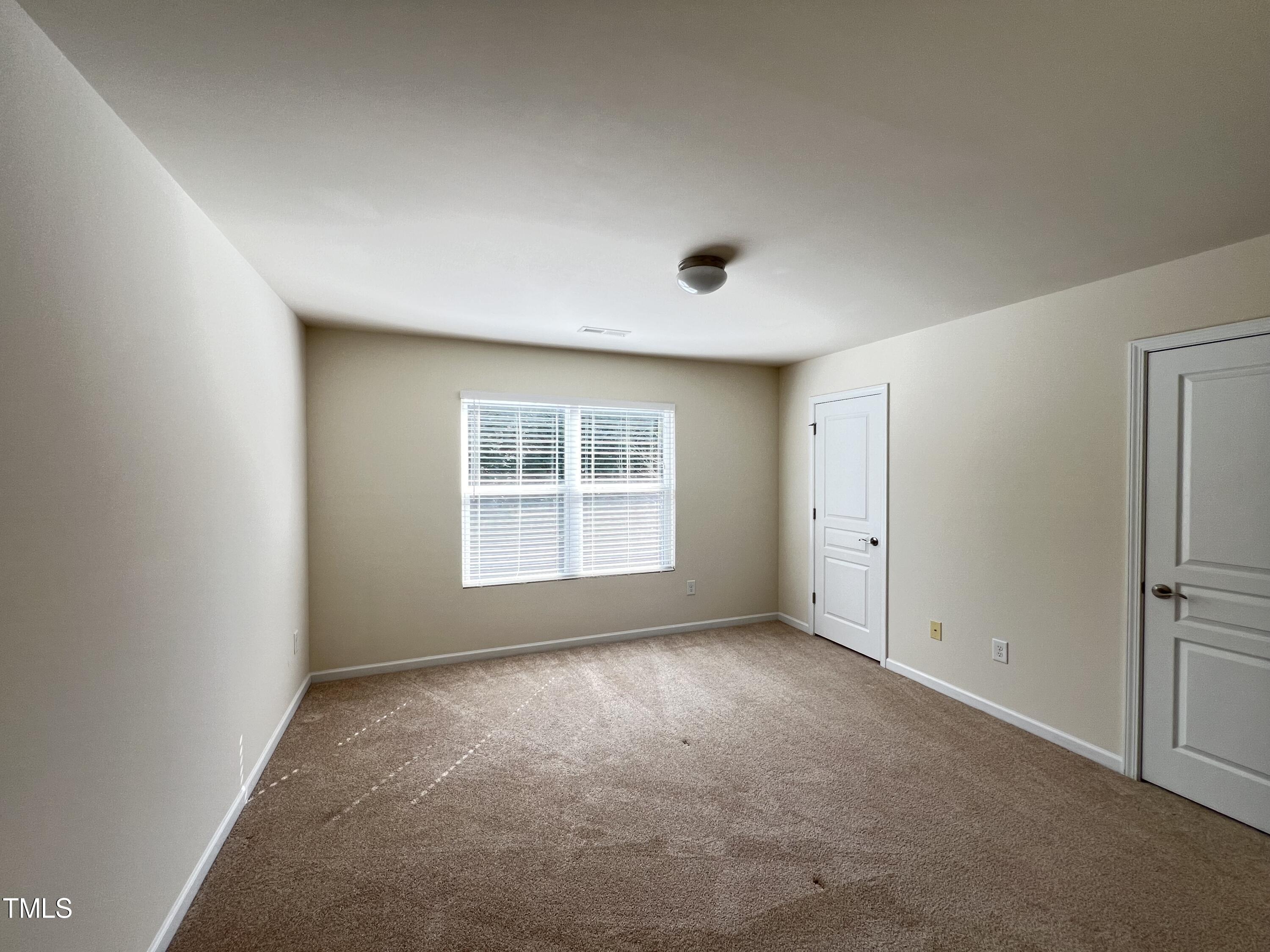 2919 Berkeley Springs Place Raleigh, NC 27616 - Photo 7 of 12 a view of an empty room with a window