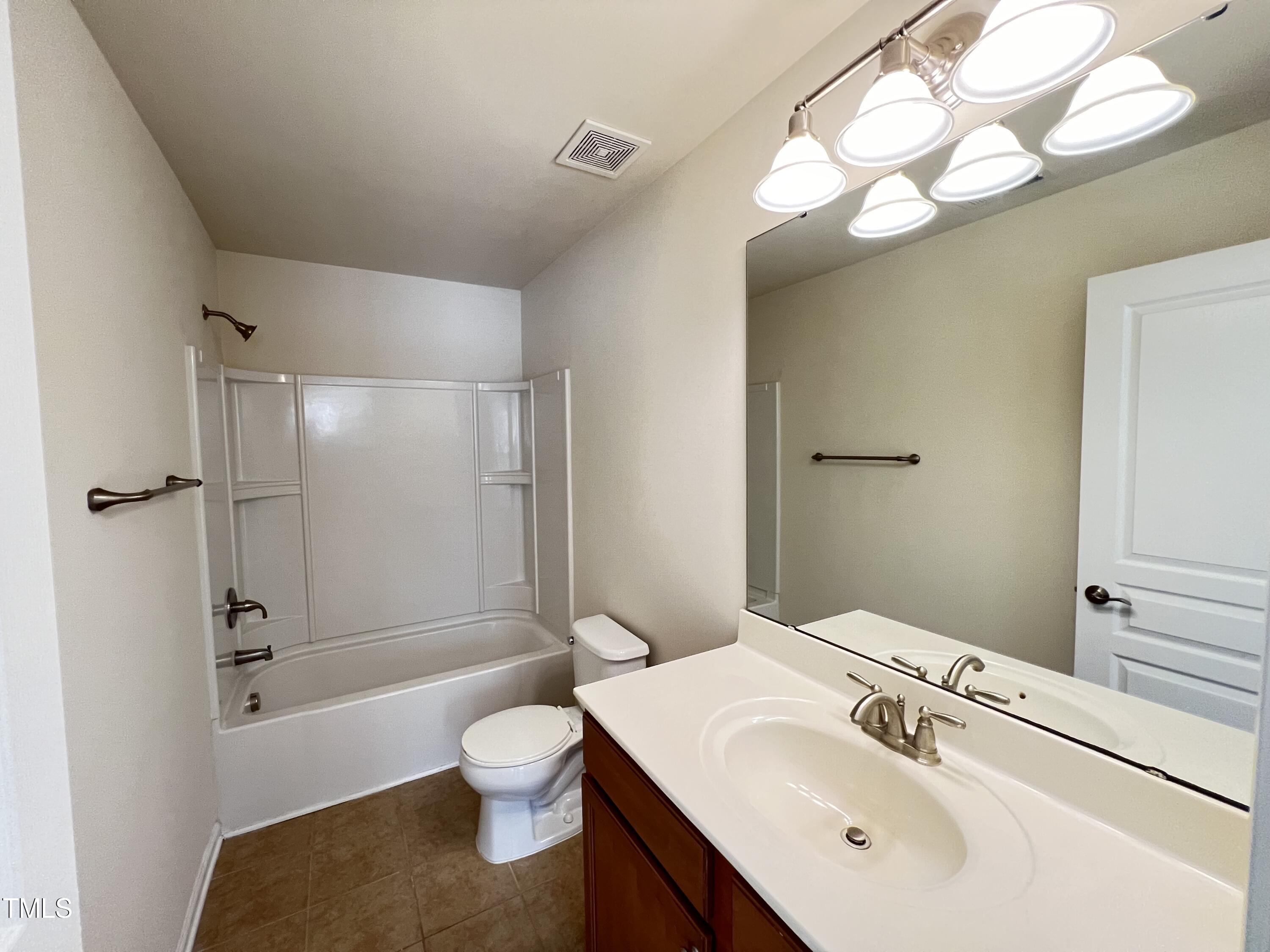 2919 Berkeley Springs Place Raleigh, NC 27616 - Photo 8 of 12 a bathroom with a sink a toilet and shower