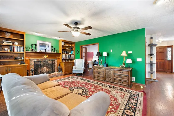 a living room with furniture ceiling fan and a rug