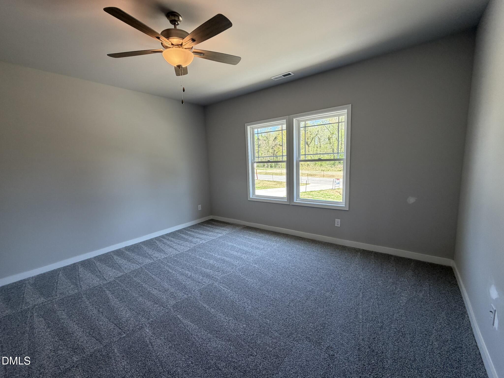 25 Jacobs Ridge Drive Four Oaks, NC 27524 - Photo 7 of 18 an empty room with a window and a fan