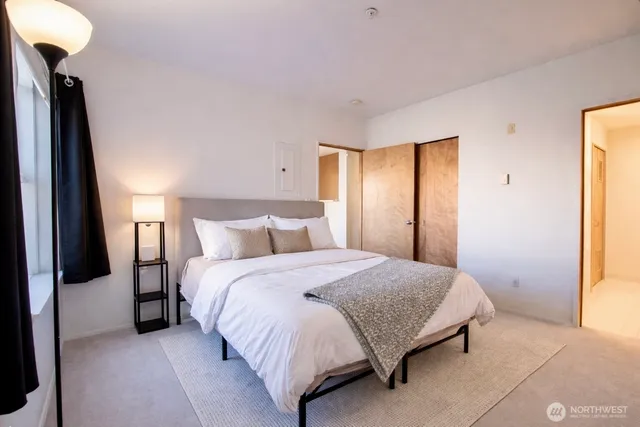 a bedroom with a bed and a window