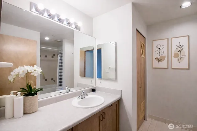 a bath room with a toilet a sink and a bathtub