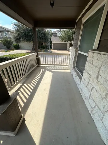 a view of balcony with wooden floor