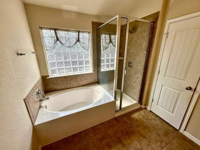 a bathroom with a tub and a shower