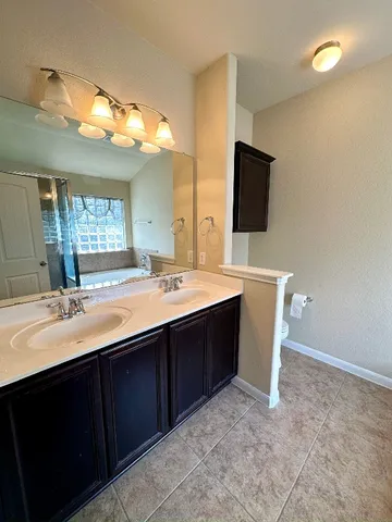 a bathroom with a sink vanity and mirror