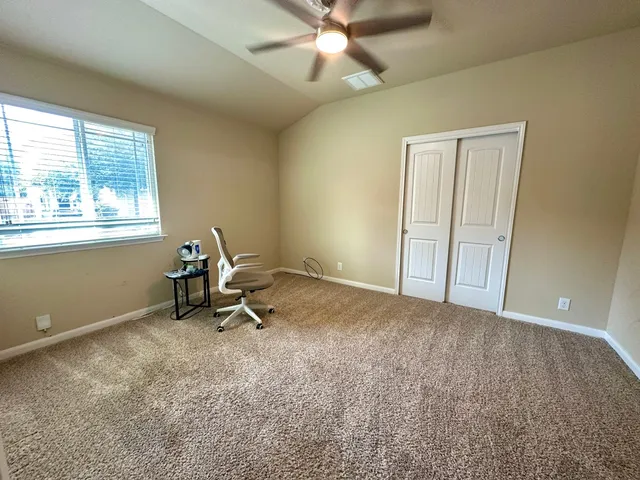 a view of a room with gym equipment and a window