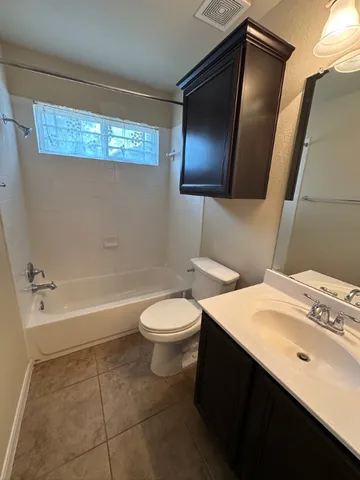 a bathroom with a sink a toilet and bathtub