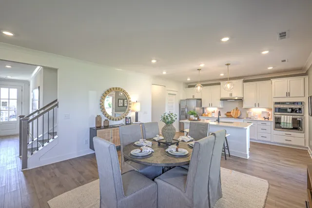 a view of a dining room with furniture and wooden floor