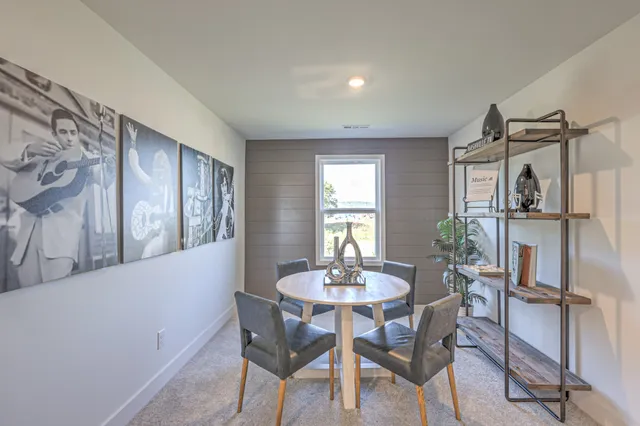 a view of a dining room with furniture and a window