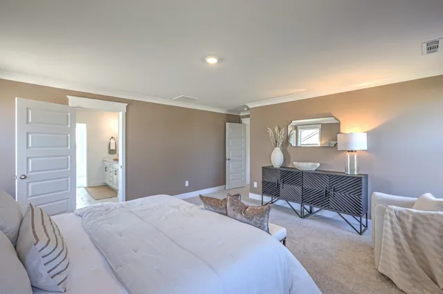 a bedroom with a bed lamps and table