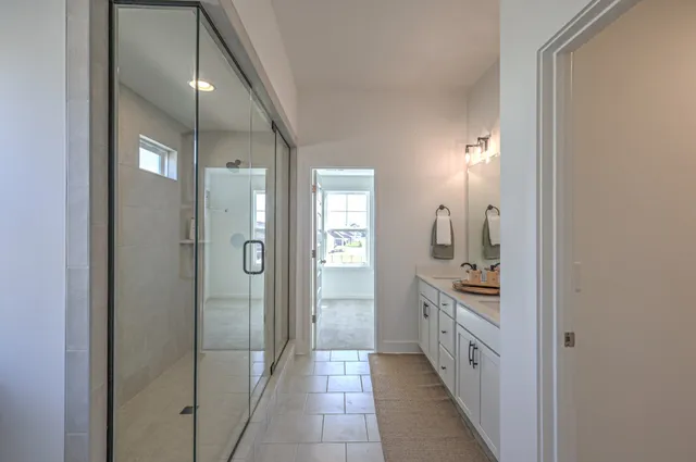 a bathroom with a double vanity sink and mirror