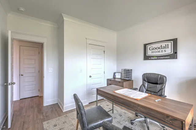 a view of a workspace with furniture and wooden floor