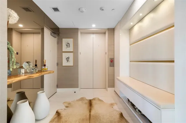 a bathroom with a sink and mirror with bathtub
