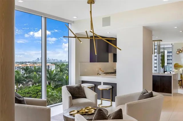 a living room with furniture and a floor to ceiling window
