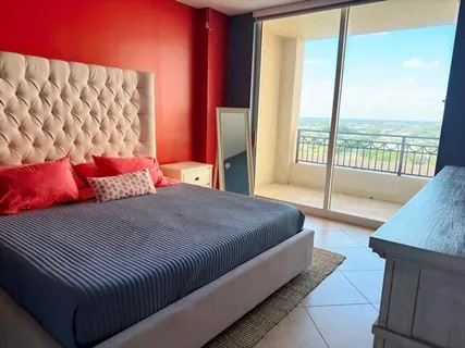 a bedroom with a large bed and a large window