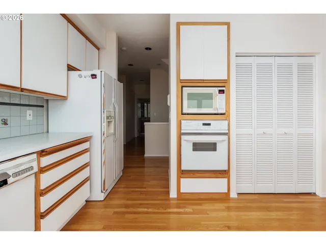 a kitchen with a sink window and cabinets