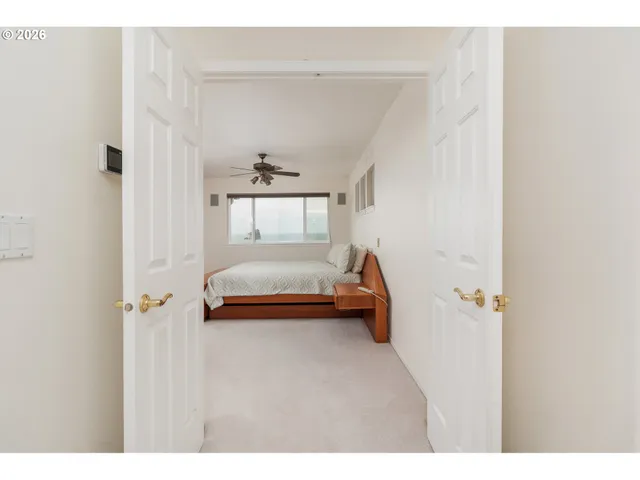 a bedroom with a large bed a flat screen tv and a couch