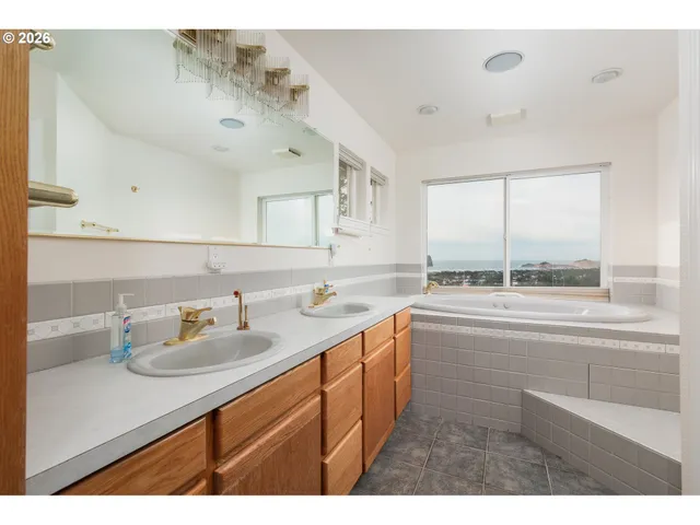a bathroom with a bathtub and a large window