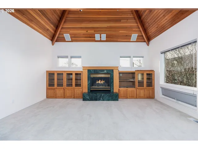 a view of empty room with a fireplace