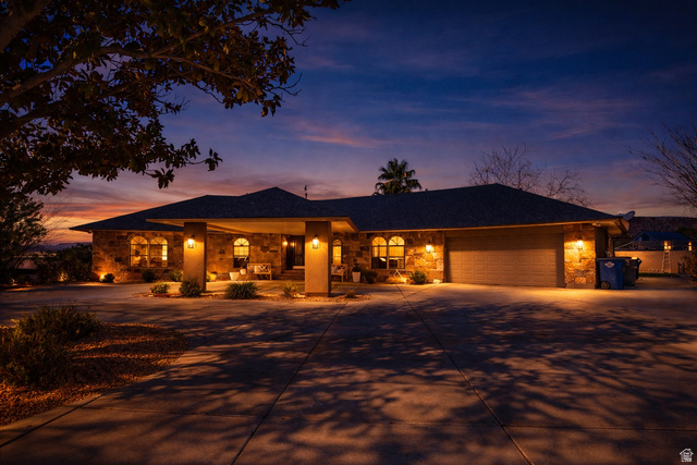980 Cactus Circle St. George, UT 84790 - Photo 76 of 77 Single story home with stone siding, concrete driveway, an attached garage, and a porch