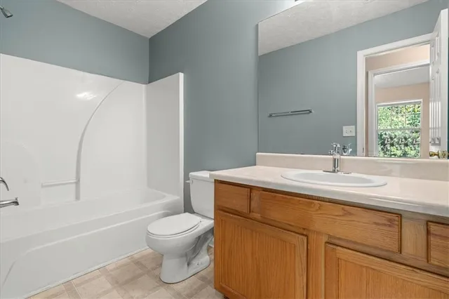 a bathroom with a sink a toilet and a bathtub