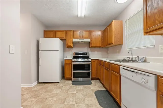 a kitchen with a refrigerator sink and stove