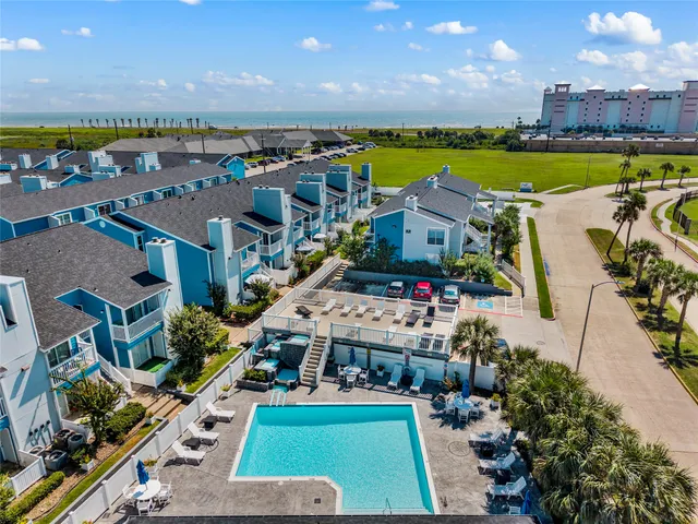 a view of a house with swimming pool and a yard