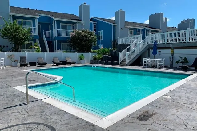 a view of a house with pool porch and sitting area