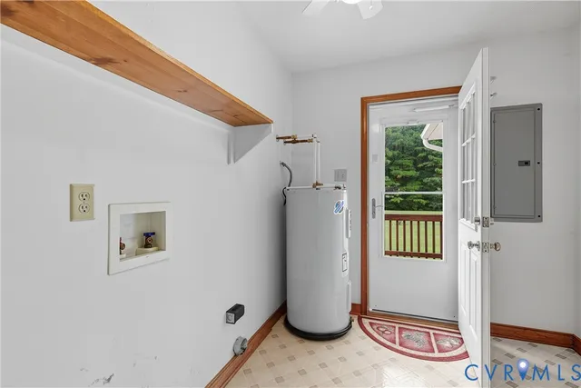 a front view of a house with a garden and lake view