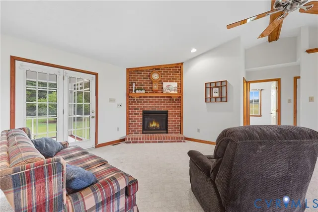 a living room with furniture a window and a fireplace